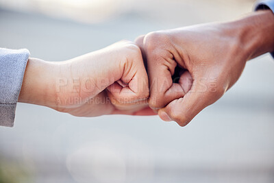 Buy stock photo Shot of two unrecognizable businesspeople giving a fist bump outside