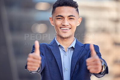 Buy stock photo Shot of a young businessman showing the thumbs up while standing outside