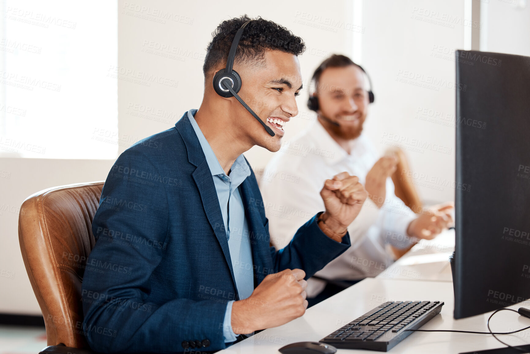 Buy stock photo Shot of a young call centre agent cheering while working in an office