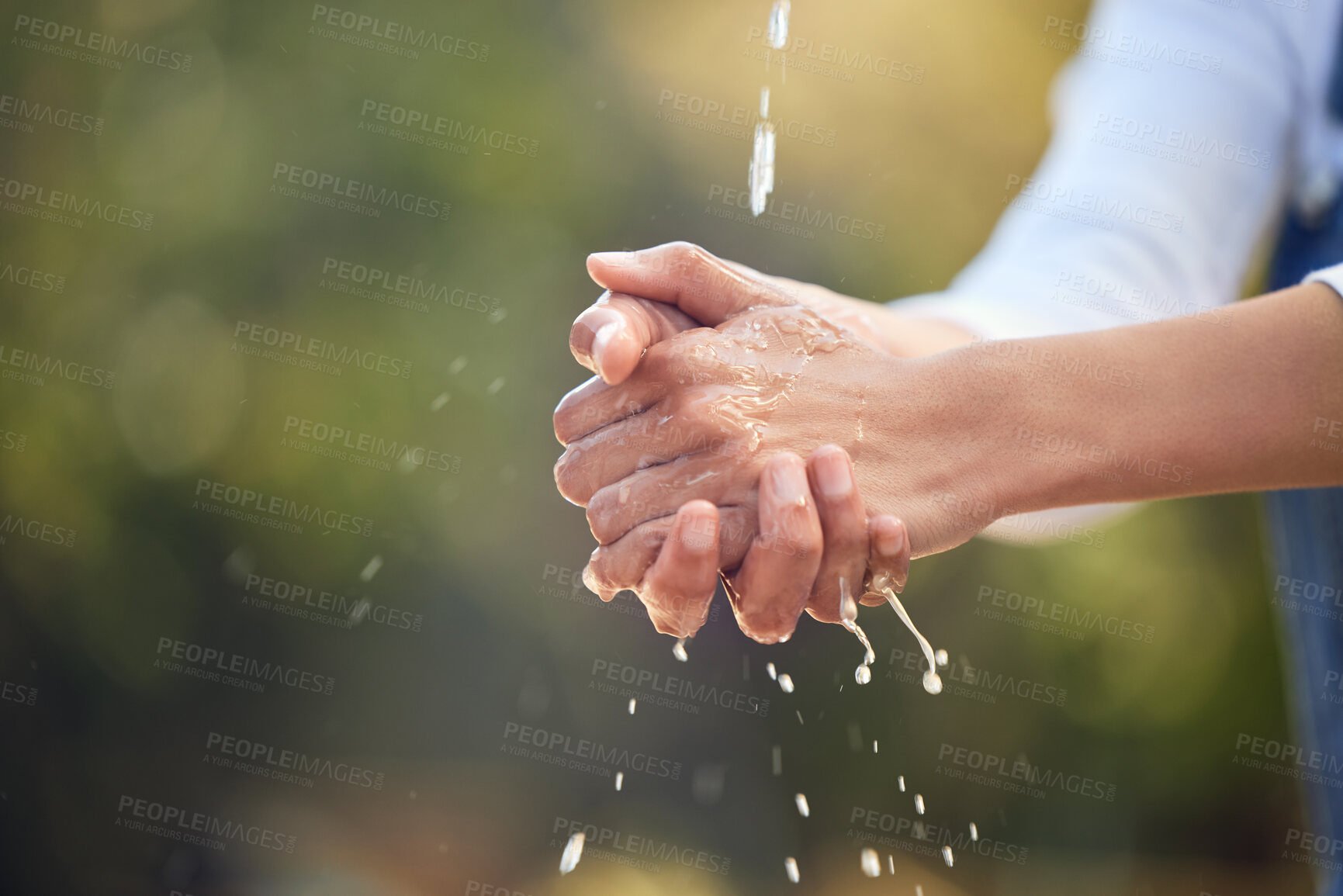 Buy stock photo Person, outdoor and water for washing hands in nature for germs, health care and sanitation for wellness in countryside. Woman, farmer and cleaning in environment with h2o for sustainability and eco.