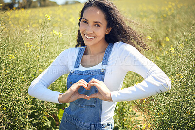 Buy stock photo Woman, portrait and smile with field, nature and flowers with heart emoji for sustainable farming. Farmer, agriculture and ecology with meadow, environment or ecology for carbon capture or green love