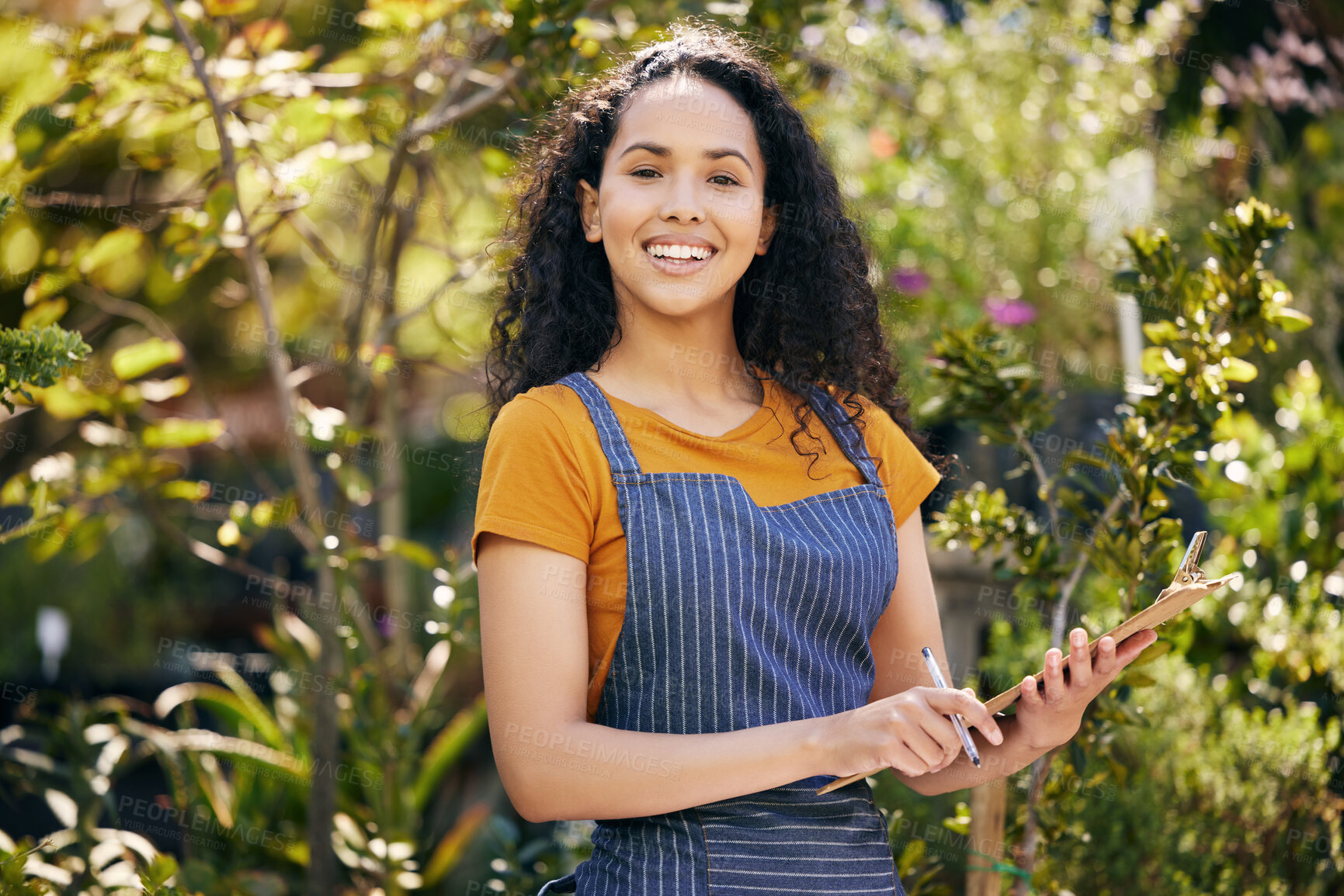 Buy stock photo Portrait, young woman or florist with clipboard in garden for writing notes, information and nursing plants. Smiling, female person or botanist with apron on for bouquets or flower arranging