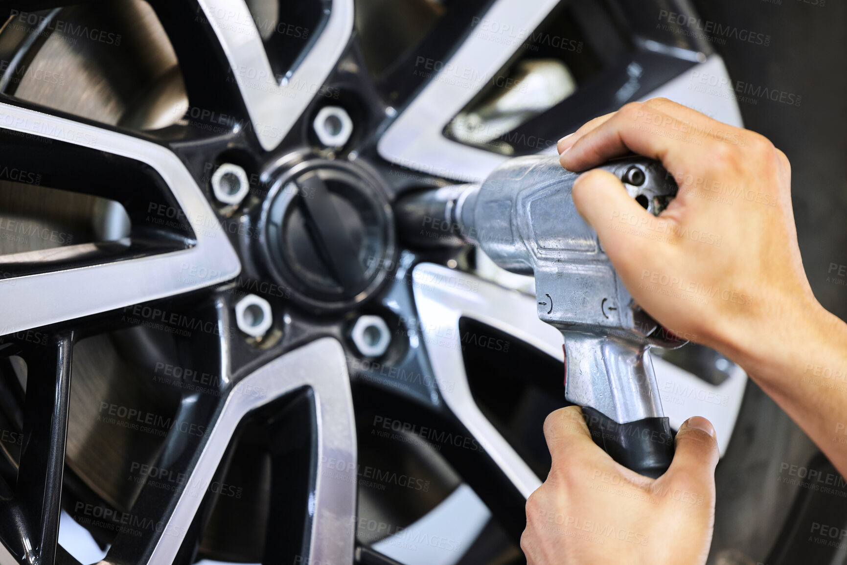 Buy stock photo Mechanic, person and hand with tools on tire for maintenance, motor safety and repair at workshop. Vehicle, inspection and automobile industry with impact wrench for car service, change and alignment