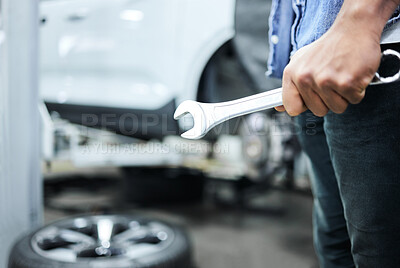 Buy stock photo Shot of an unrecognizable male mechanic working on the engine of a car during a service
