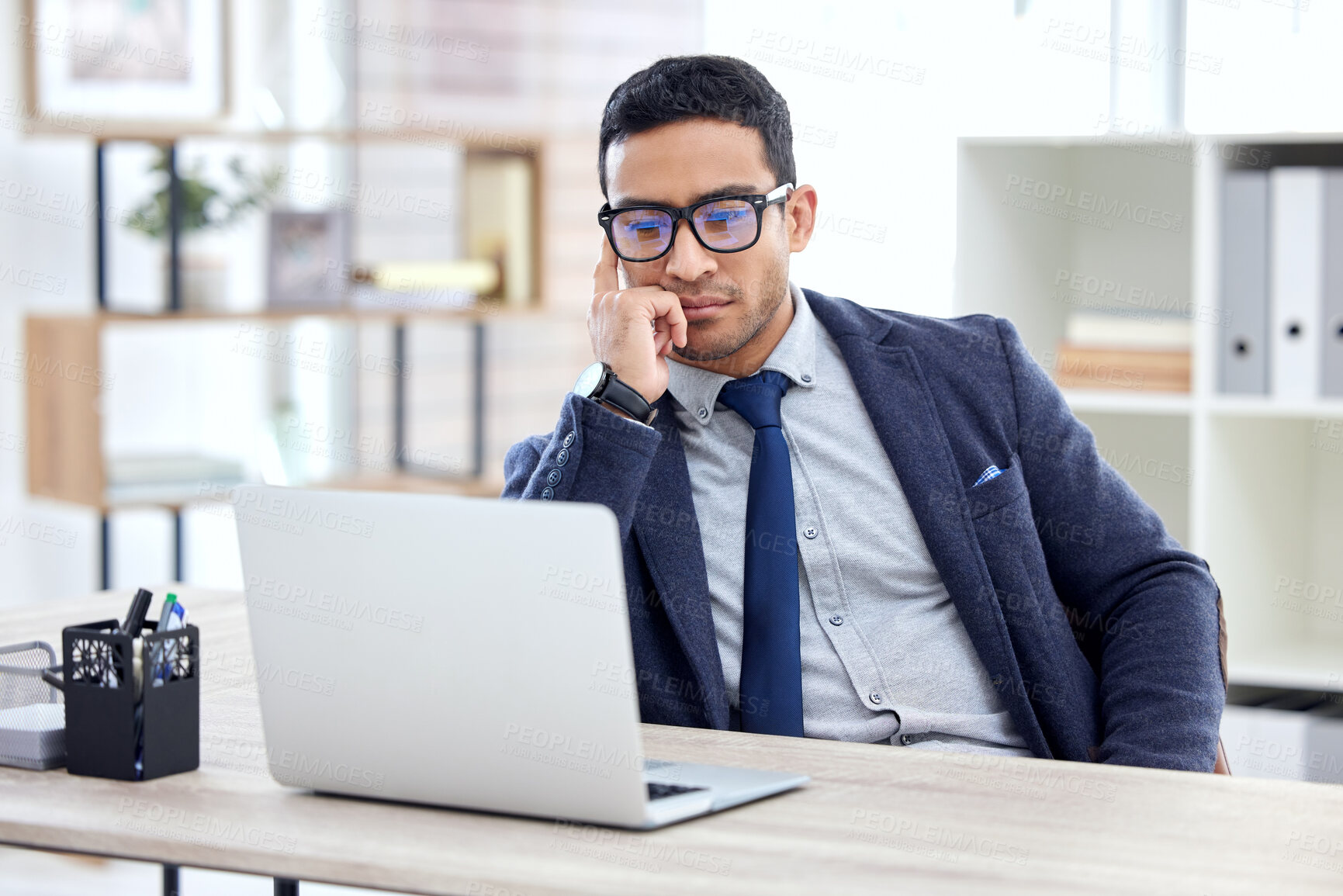 Buy stock photo Businessman in glasses, thinking or reading on laptop in office, desk or corporate workplace with professional employee. Man, business and focus on working, planning or entrepreneur busy on computer