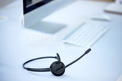 Buy stock photo Shot of a headset on a desk in a modern office