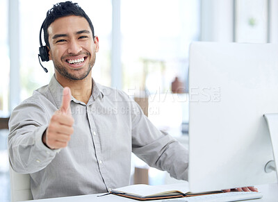 Buy stock photo Shot of a young businessman using a headset and showing thumbs up in a modern office