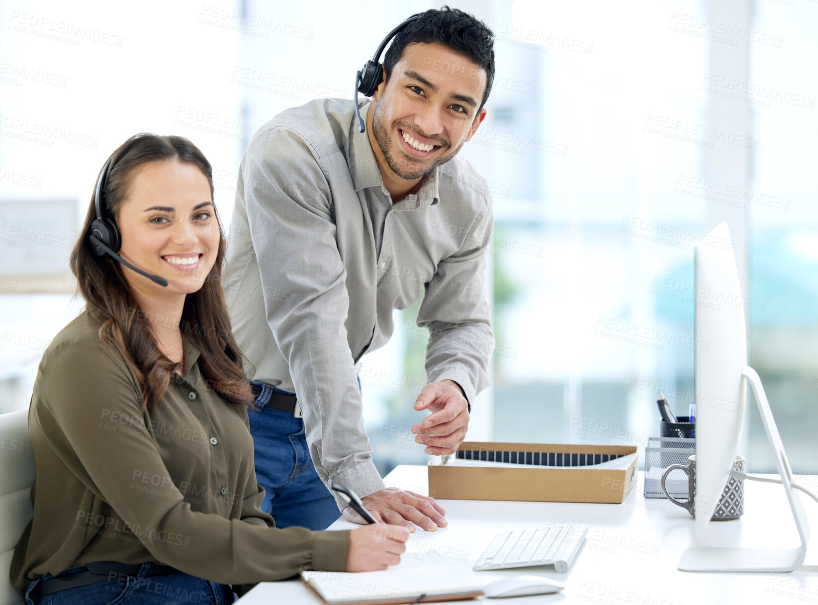 Buy stock photo Call center, man coaching woman and smile in portrait, office and writing notes for learning at telemarketing job. Crm, teaching and notebook for customer service, consulting and tech support with pc