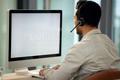 Buy stock photo Call center, man and back with computer, typing and blank screen for copy space, telemarketing and mockup. Young male consultant, pc and customer service with advice, email or communication in office