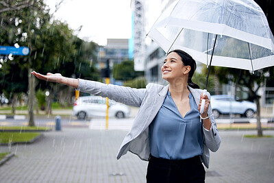 Buy stock photo Rain, happy and woman in winter with an umbrella or cold weather in a city street or road and travel in urban town. Corporate, young and employee walking in happiness with a smile in the morning