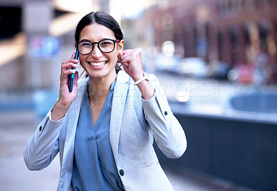Buy stock photo Shot of a young businesswoman cheering in happiness during a phone call