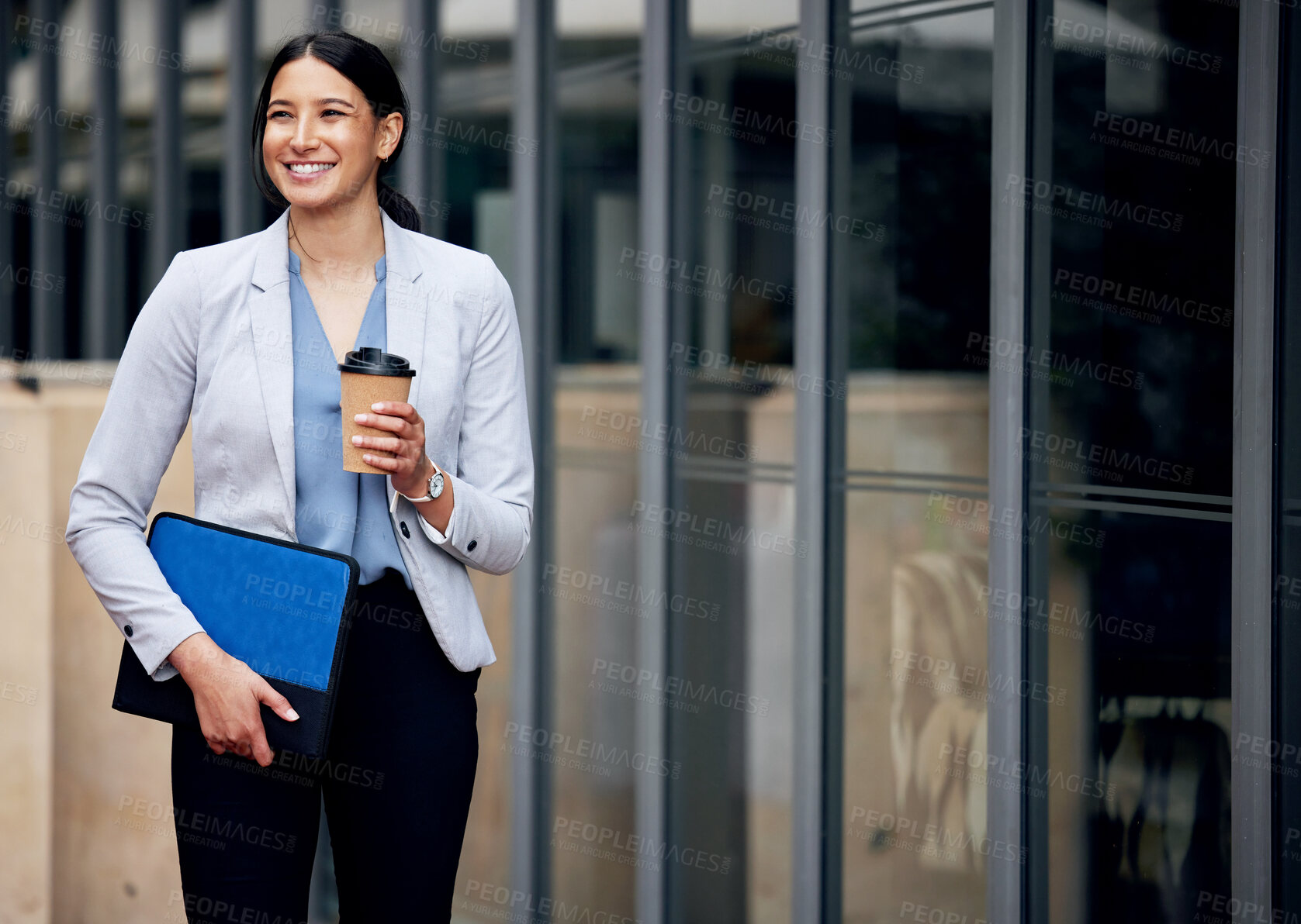 Buy stock photo Shot of a young businesswoman enjoying a cup of coffee while making her way work