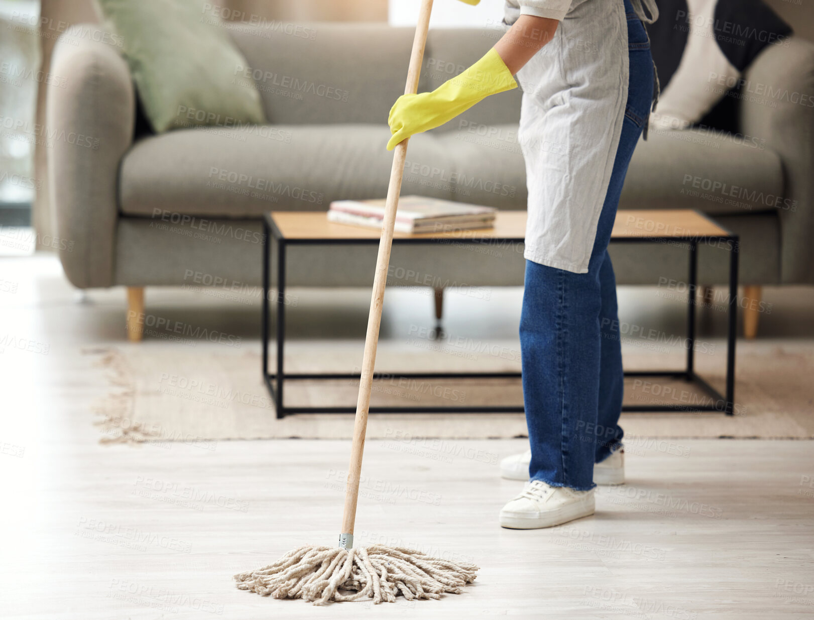 Buy stock photo Shot of an unrecognizable woman mopping the floors at home