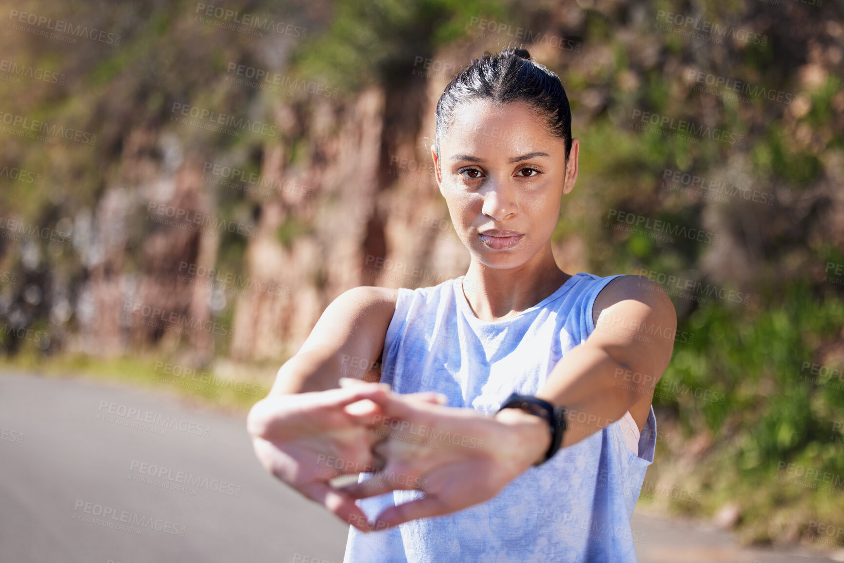 Buy stock photo Cropped portrait of an attractive young female athlete warming up for an outdoor run