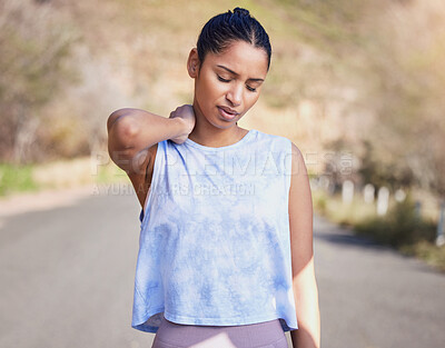 Buy stock photo Cropped shot of an attractive young female athlete suffering from a bit of cramp while out for a run