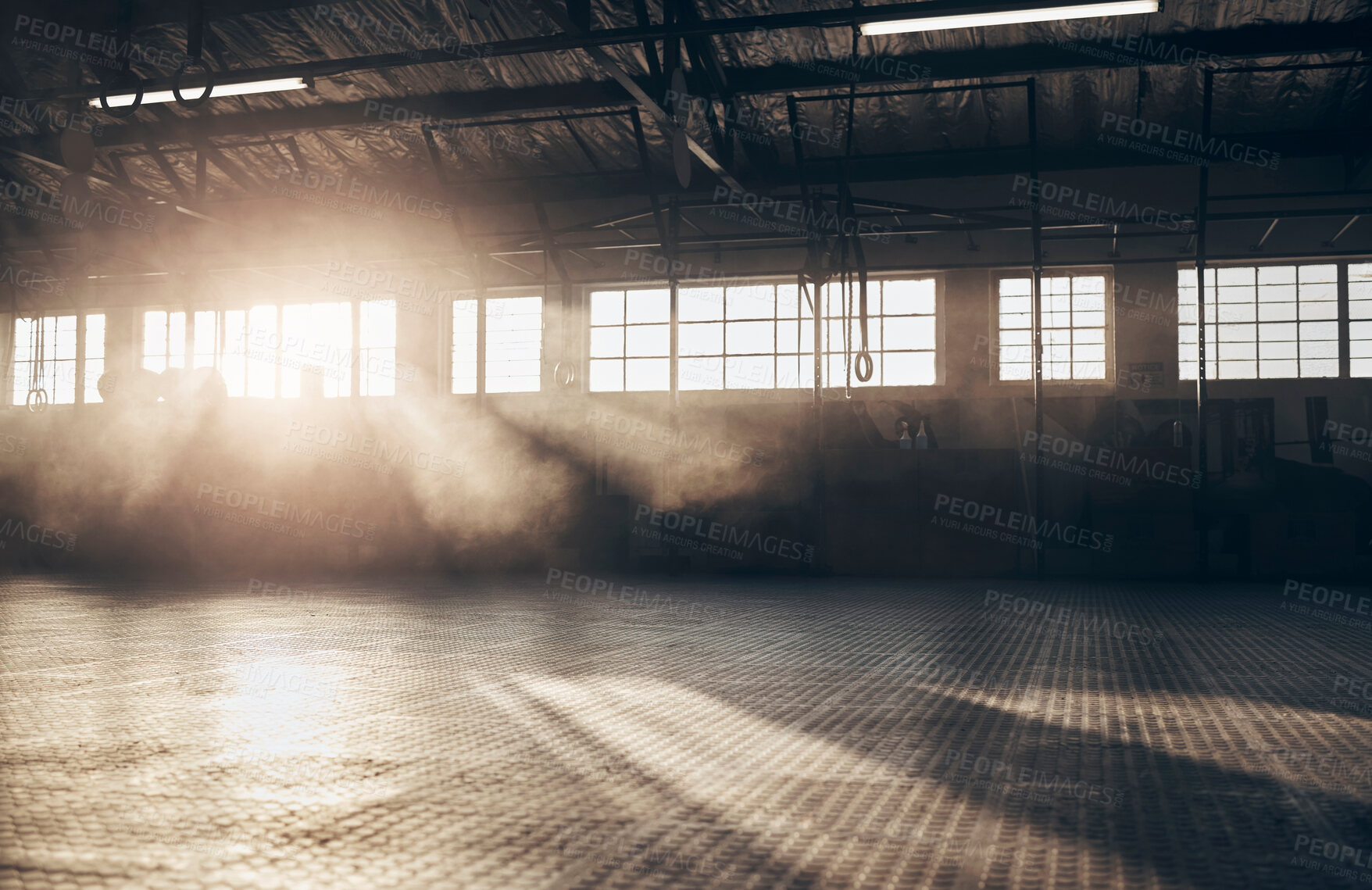 Buy stock photo Empty, gym and interior space or dark room with window and light flare for exercise, training and fitness workout. No people, sports club and floor layout of exercising venue, facility and gymnasium