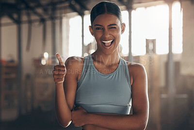 Buy stock photo Woman in gym, thumbs up with wink in portrait, like fitness with emoji and health goals with sport and mockup space. Hand gesture, yes and motivation with Indian female athlete at exercise studio