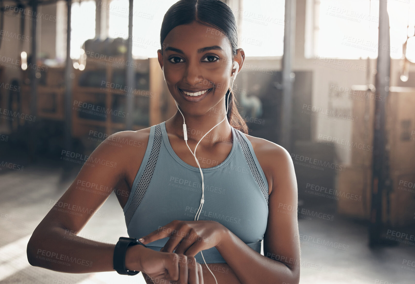 Buy stock photo Woman, gym portrait and point at watch, fitness or schedule for workout, training or wellness. Indian girl, personal trainer and time for exercise with smile, music or audio streaming subscription