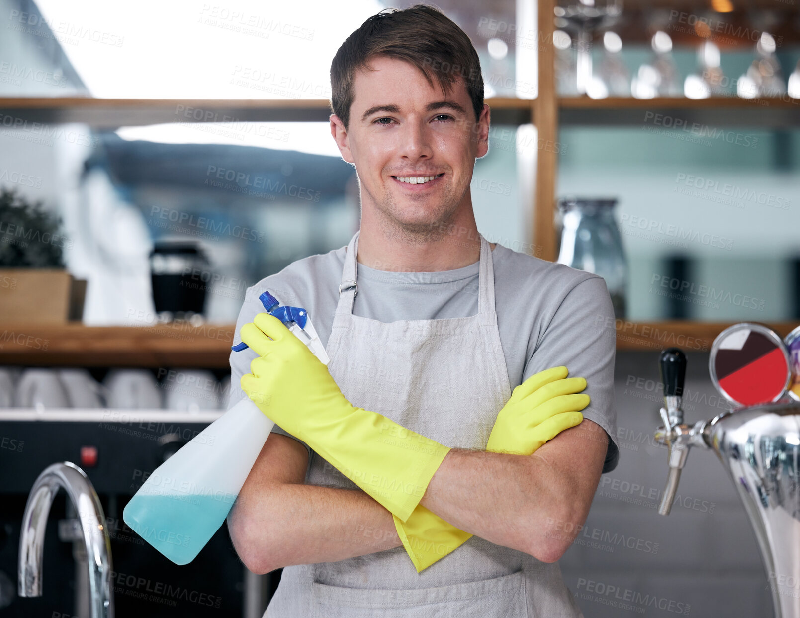 Buy stock photo Crossed arms, spray bottle and portrait of man in kitchen with gloves for cleaning or housekeeping. Smile, confident and male cleaner with liquid detergent for dirt, bacteria or germs at apartment.