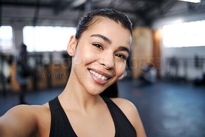 Buy stock photo Portrait of a fit young woman taking selfies at the gym