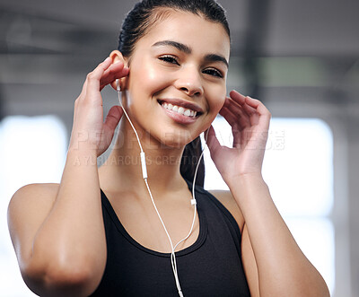 Buy stock photo Girl, earphones and portrait at gym for fitness, music and motivation for workout or exercise. Female person, athlete listening and audio for cardio, sports and wellness podcast for training at club