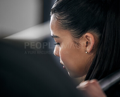 Buy stock photo Rearview shot of a young woman working out with a barbell in a gym