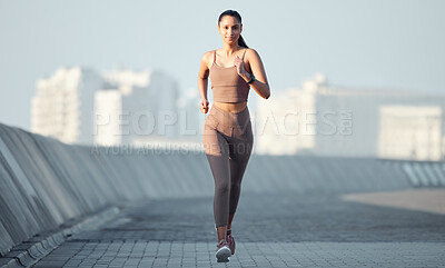 Buy stock photo Portrait of a sporty young woman running outdoors