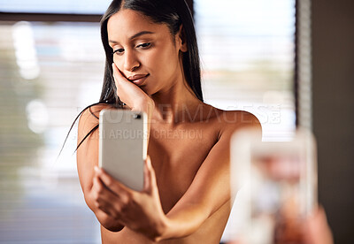 Buy stock photo Shot of a beautiful young woman taking a topless selfie