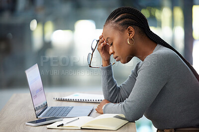 Buy stock photo Mental health, businesswoman with headache and laptop at her desk in modern workplace office. Anxiety or burnout,  problem or mistake and African woman stress or tired at her workspace with notebook