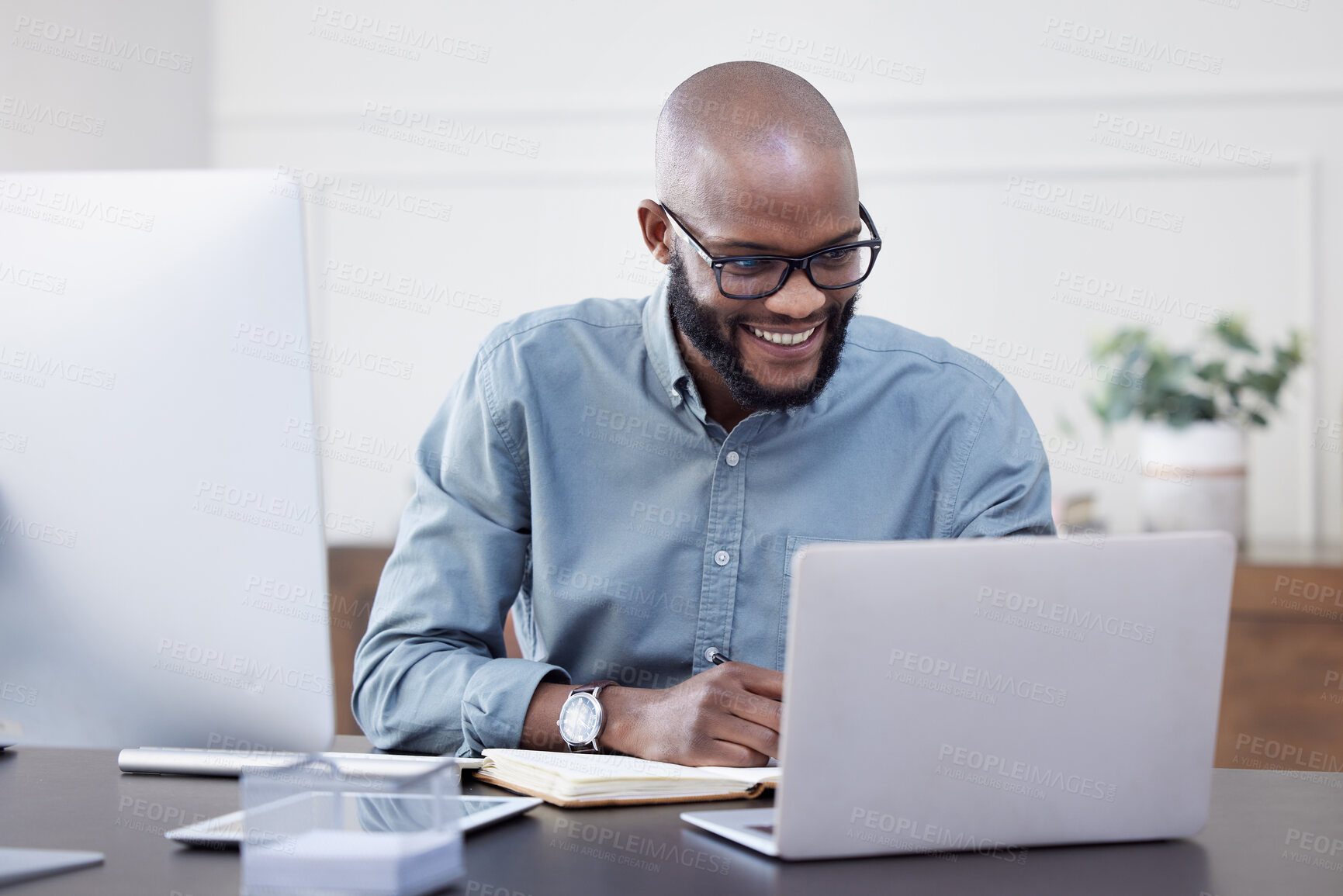 Buy stock photo Laptop, writer and black man with notebook, smile and working on business project in office. Computer, happy and African professional taking notes, copywriting or research, planning and reading email