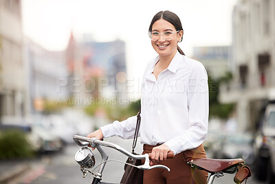 Buy stock photo Portrait of a young woman using her bicycle to explore the city