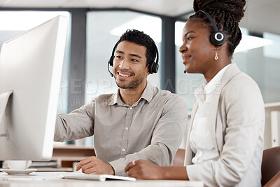 Buy stock photo Shot of two colleagues working in a call center