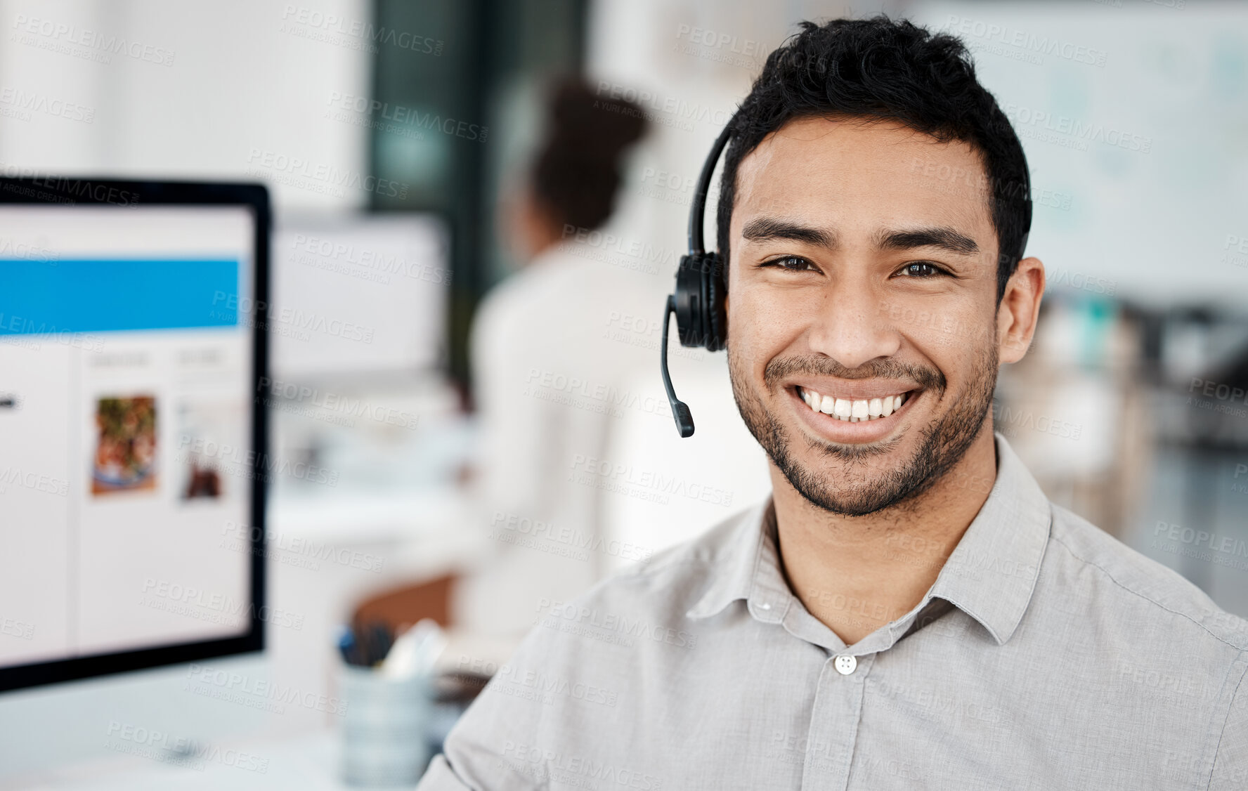 Buy stock photo Shot of a young businessman wearing a headset while working in an office