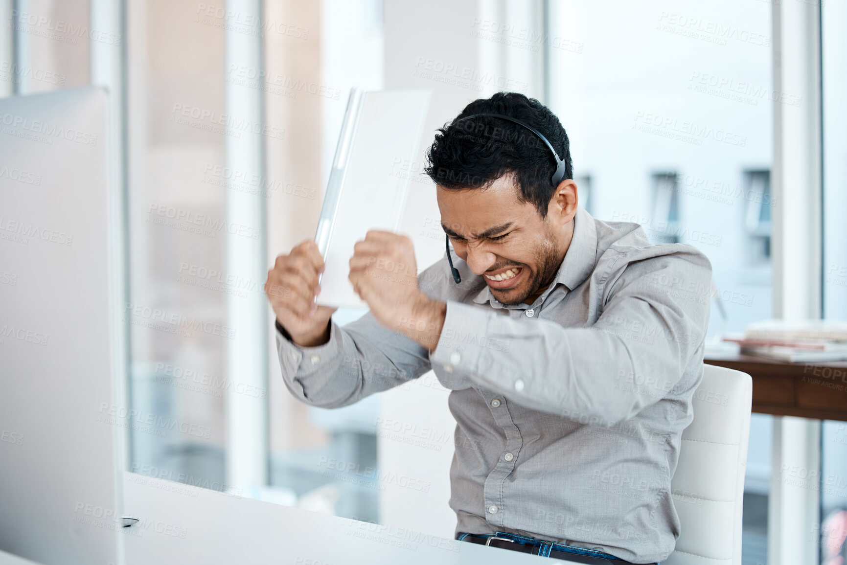 Buy stock photo Angry, frustrated and consultant breaking keyboard and fail or computer glitch in a call center or agency office. Stress, insurance and man employee with a problem and risk to the company or business