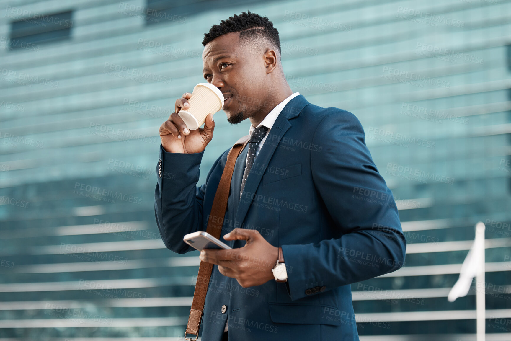 Buy stock photo Shot of a young businessman drinking coffee while using his smartphone