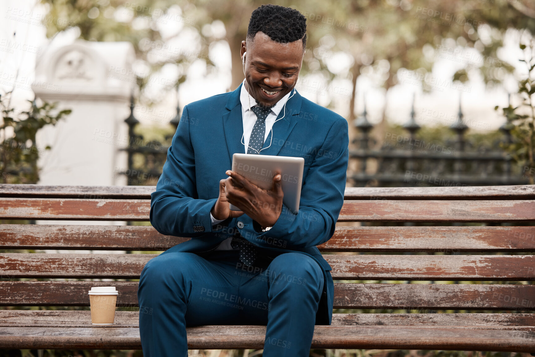 Buy stock photo Shot of a happy businessman using his digital tablet