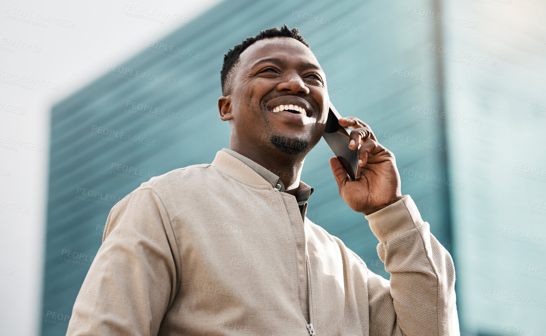 Buy stock photo Phone call, business and laughing black man in city for talking or consultant listening to contact in low angle. Mobile, funny and African professional outdoor for deal, negotiation or travel news