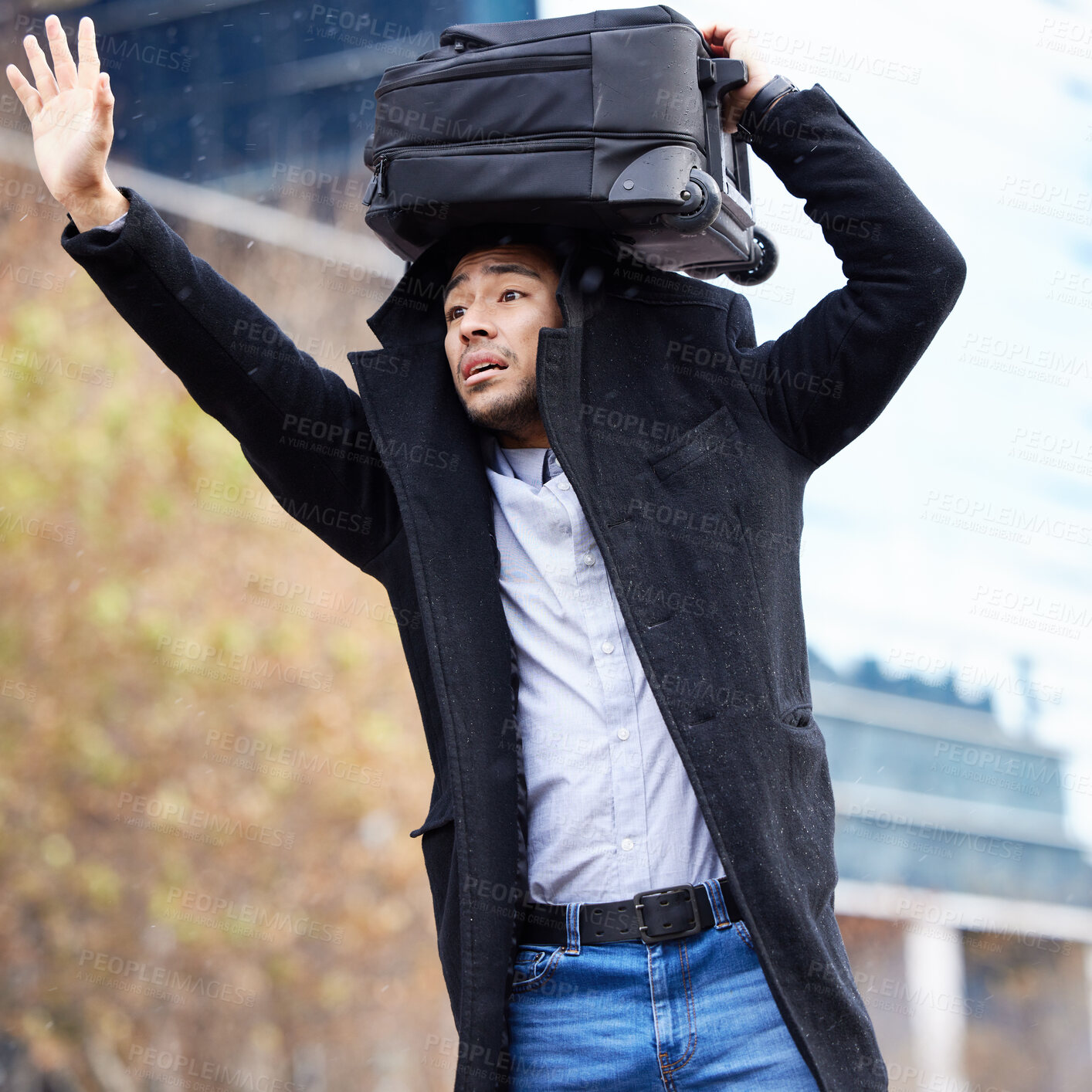 Buy stock photo Man, rain and waiting for taxi in city with luggage on head, sign and wave for driver in street. Business person, sidewalk and stop car for ride, transport or travel with storm on commute to airport