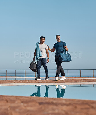 Buy stock photo Shot of two young men going for a swim
