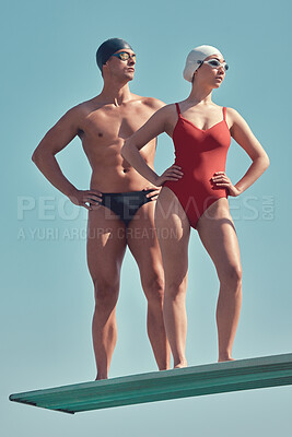 Buy stock photo Full length shot of two young athletes standing on a diving board outside