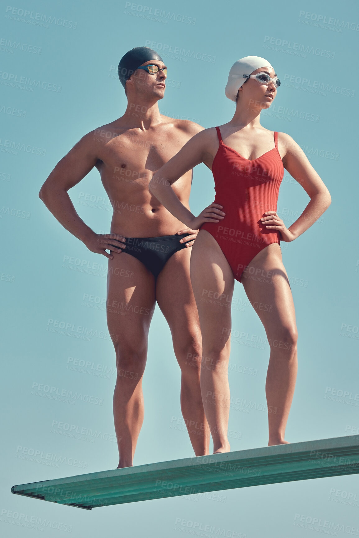 Buy stock photo Full length shot of two young athletes standing on a diving board outside