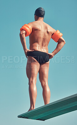 Buy stock photo Rearview shot of an unrecognizable male athlete standing on a diving board outside