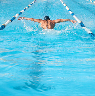 Buy stock photo Shot of an unrecognizable young male athlete swimming in an olympic-sized pool
