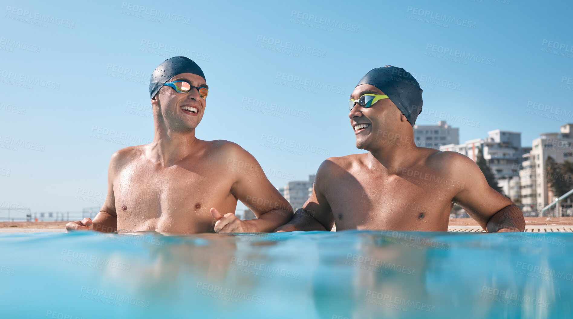 Buy stock photo Shot of two young men going for a swim in an olympic pool