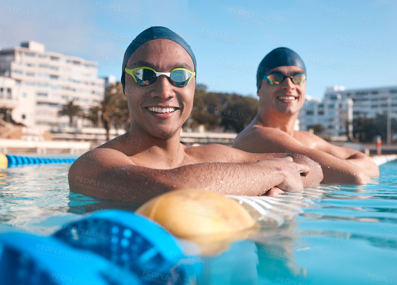 Buy stock photo Portrait of two young men going for a swim in an olympic pool