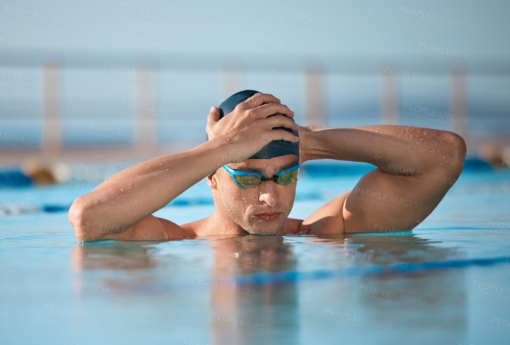 Buy stock photo Shot of a handsome young male athlete swimming in an olympic-sized pool