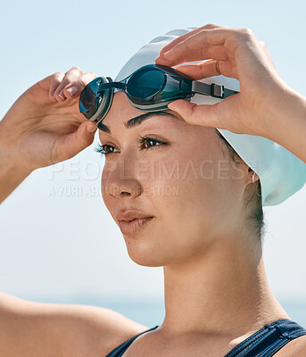 Buy stock photo Shot of a young female athlete preparing to swim in a pool outside