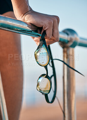 Buy stock photo Shot of a unrecognizable swimmer holding goggles