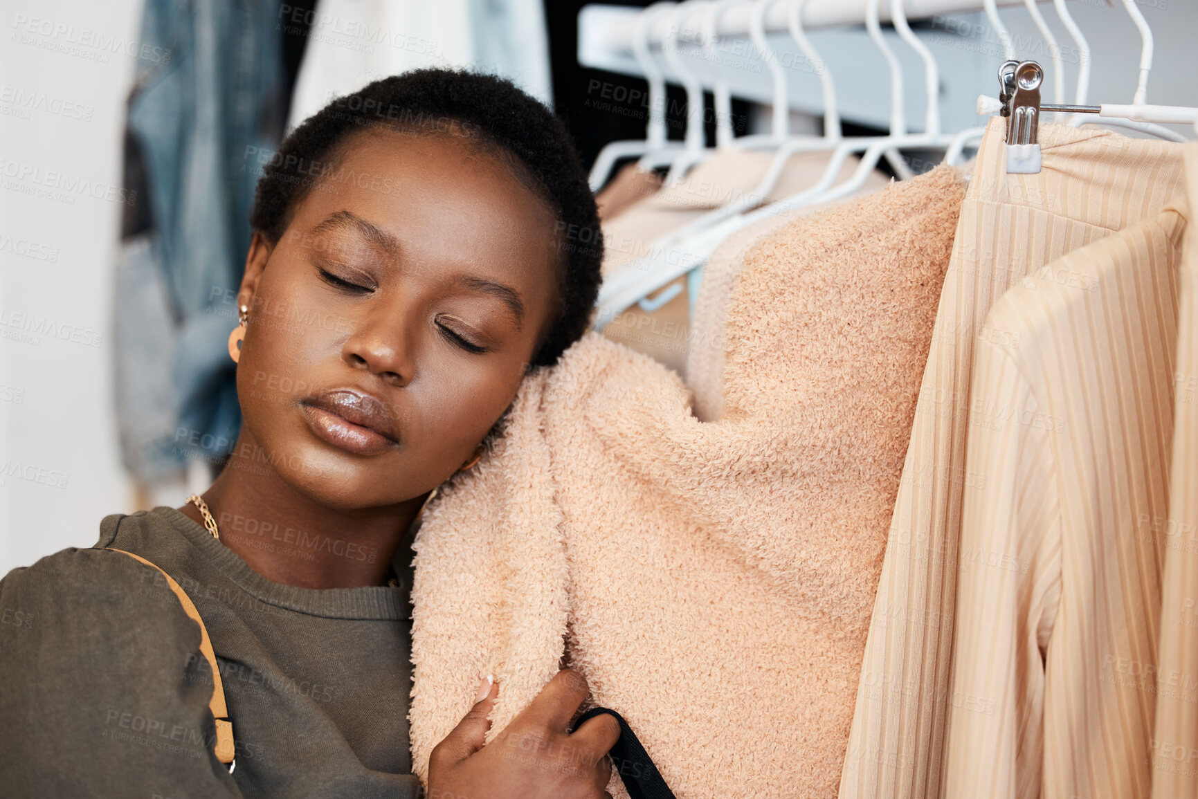 Buy stock photo Shot of a beautiful young woman shopping for clothing at her favourite boutique