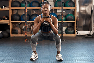 Buy stock photo Exercise, fitness and kettlebell with woman squat, workout and gym challenge with weight. African female person, strength training and wellness with sport for muscle and athlete in a health center